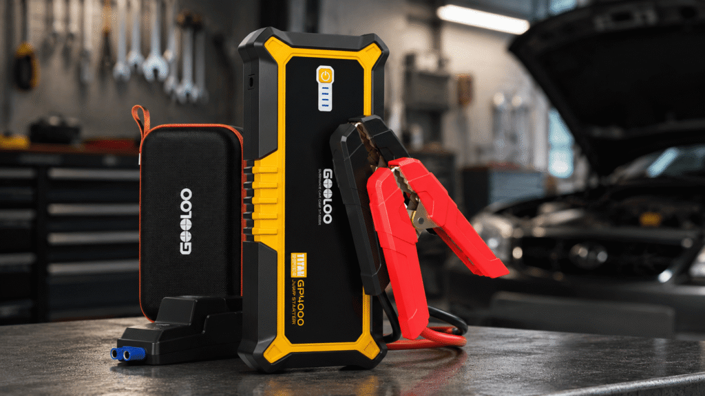 GOOLOO GP4000 4000A vehicle battery jump starter with clamps and carrying case in a garage setting