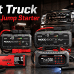 Best truck battery jump starter options displayed in a garage with a pickup truck in the background